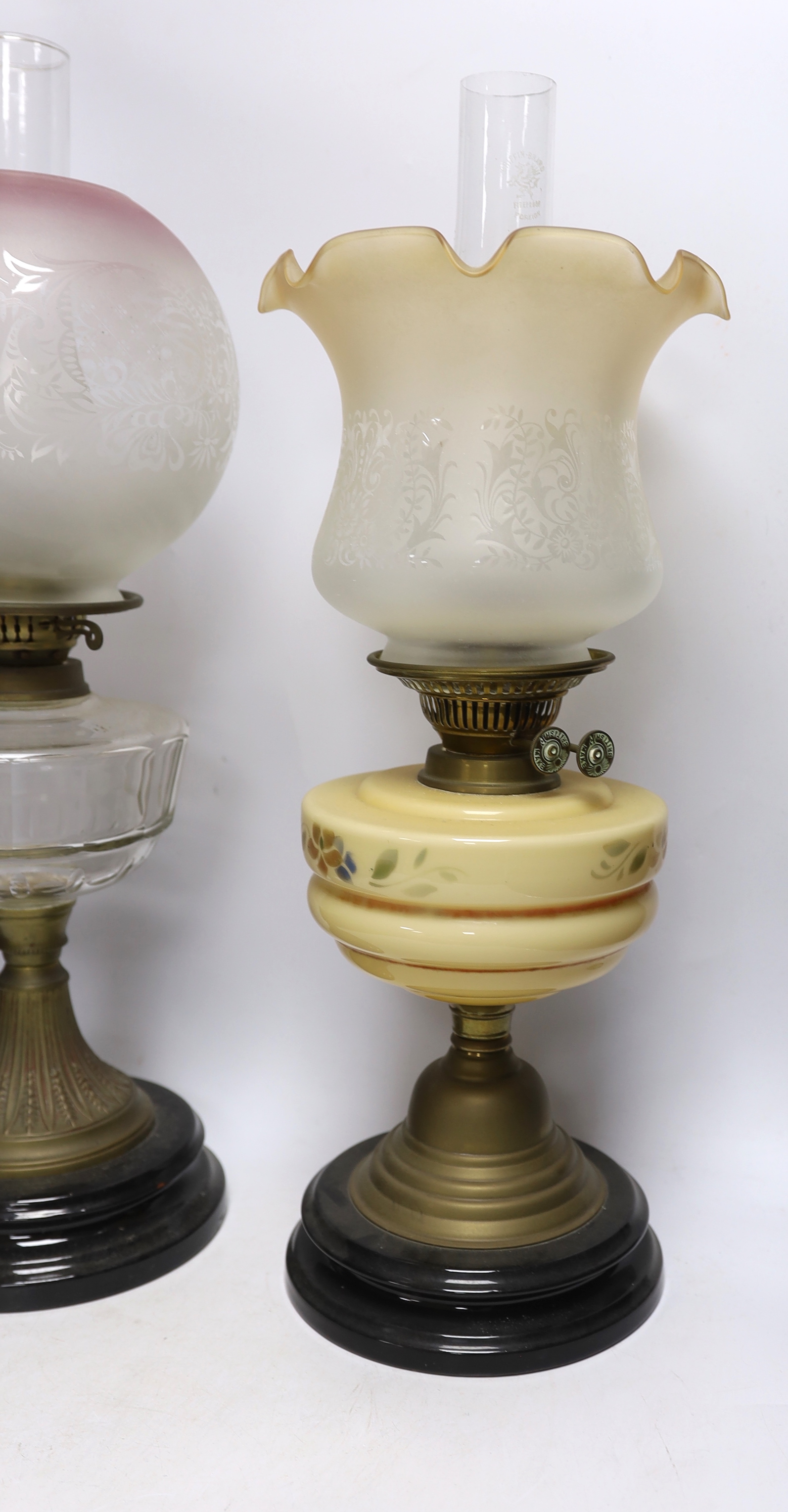 Three glass and brass oil lamps, c.1900, tallest 57cm